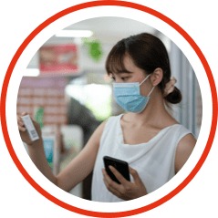 Female in a store shopping with her mobile phone and mask on her face