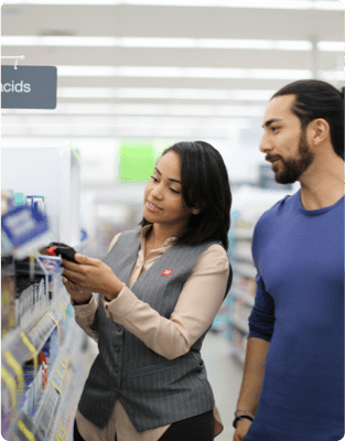 Walgreens employee showing a product to a customer